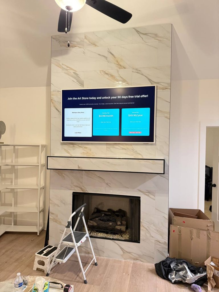 Professional TV mounting above a wooden media console by TV Mount Company.