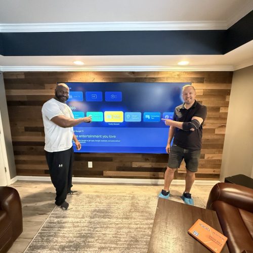 Professional TV mounting on a wood accent wall by TV Mount Company.